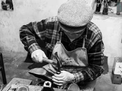 ...sul tacco di quest'ultima, ora rivolto verso il suo viso, viene applicato un rivestimento in gomma grazie alla pressione di sapienti martellate